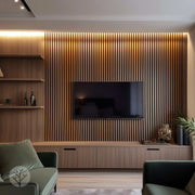 Modern living room with wooden slat wall, TV, and shelves.