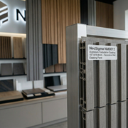 Metallic panel with a label in an indoor setting, possibly a showroom.