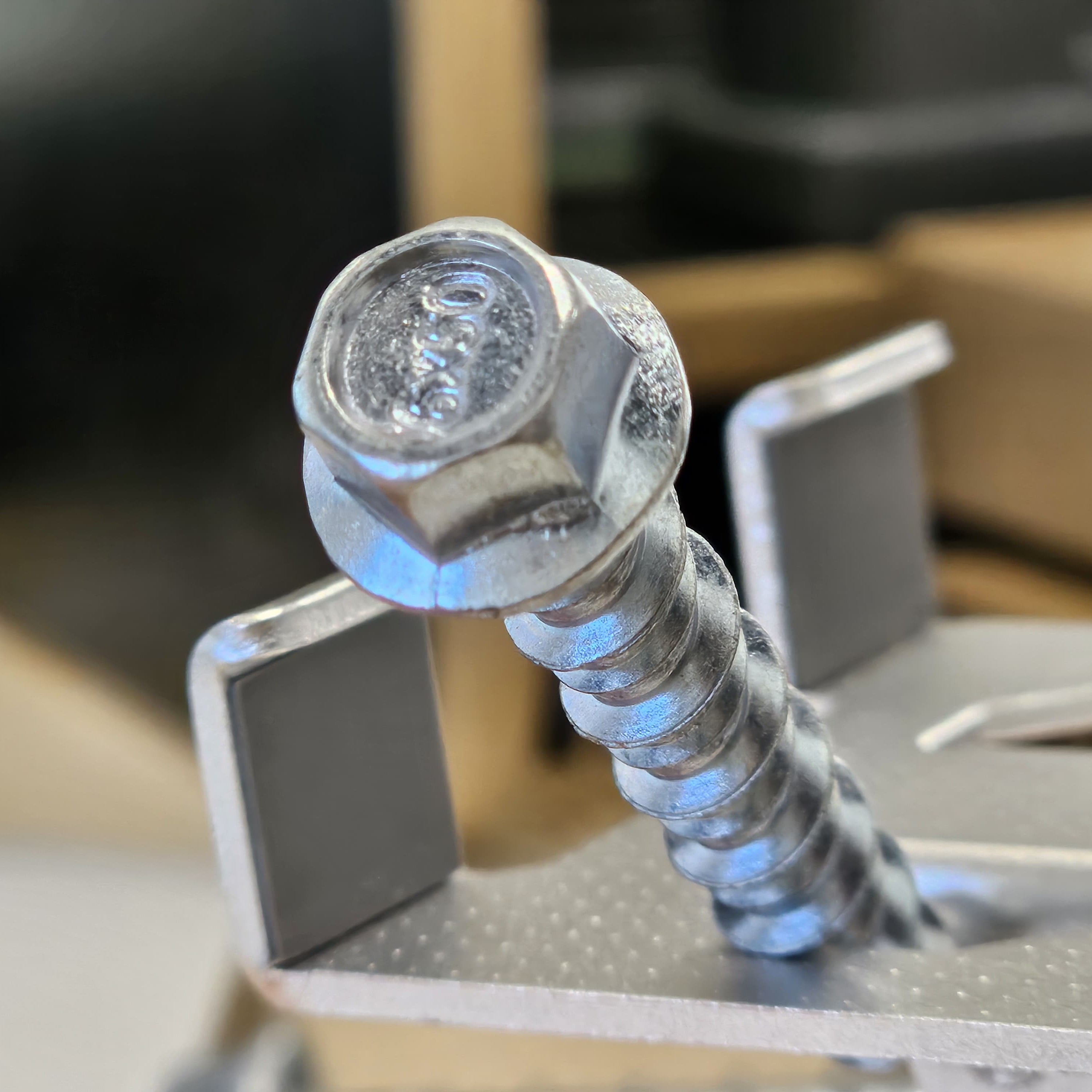 Close-up of a metal screw on a blurred background