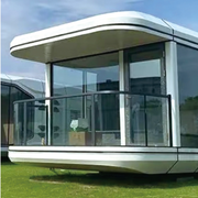 Modern modular building with glass walls on a grassy area