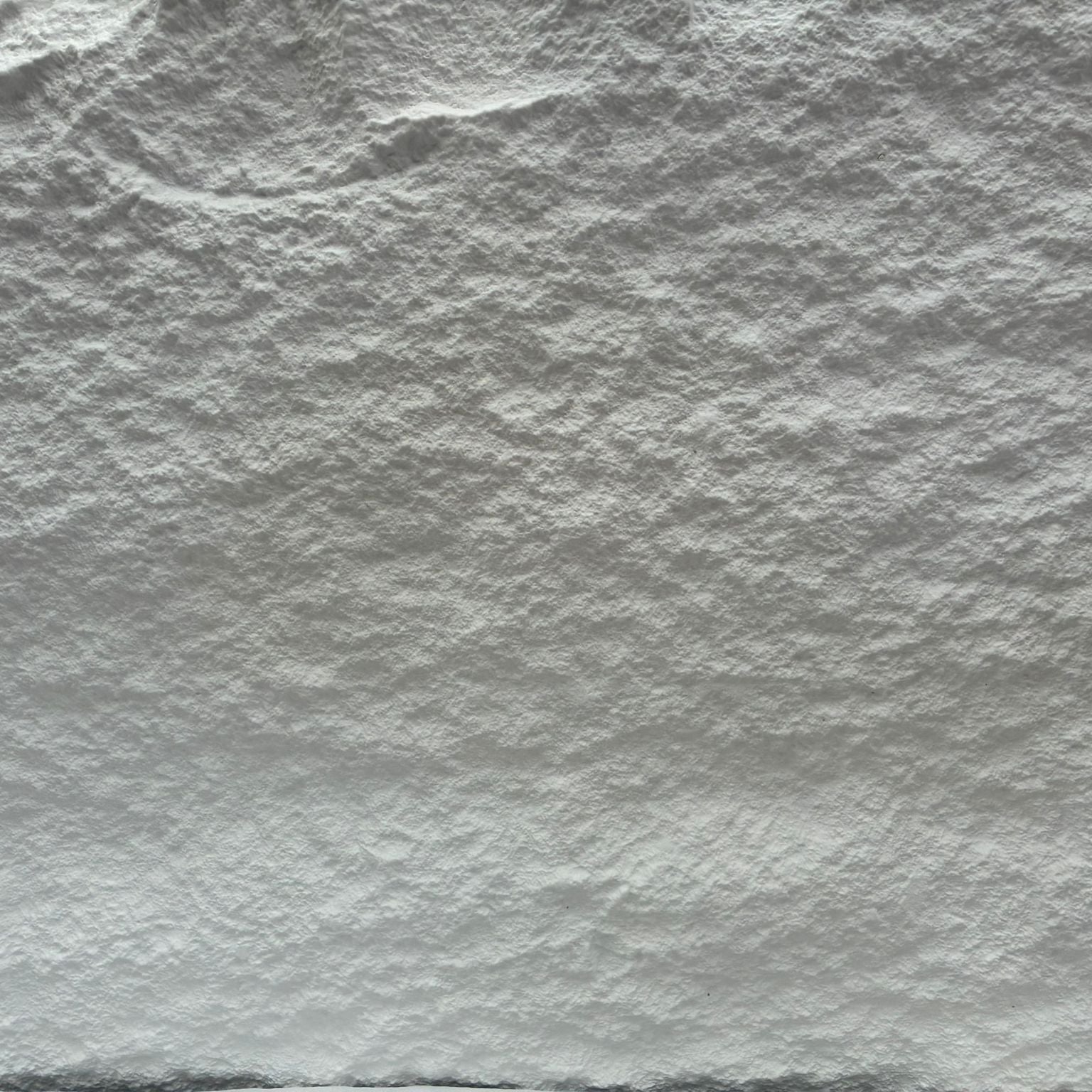 Close-up of textured white stone surface