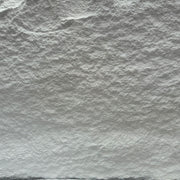 Close-up of textured white stone surface