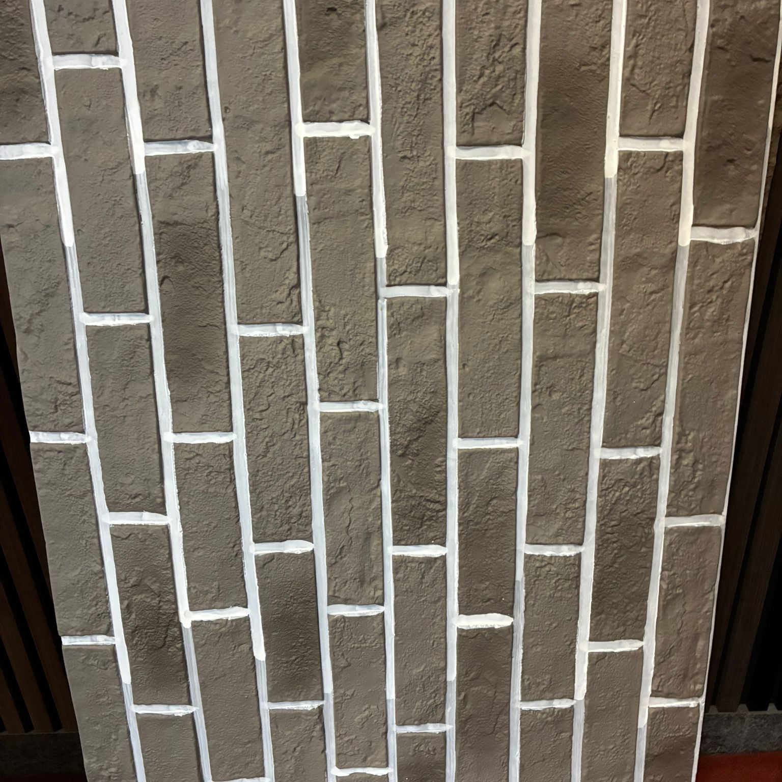Rectangular stone tiles arranged in a pattern on a wall.
